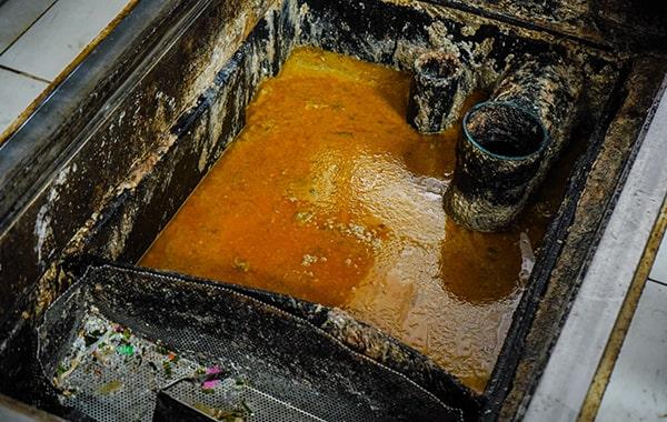 foul odors, slow drainage, and visible grease build-up are all signs that your grease trap might need cleaning